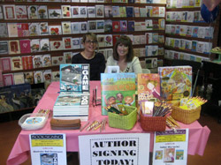 Valerieo,co-owner of Apostrophe Books, takes a photo opt with Alva.